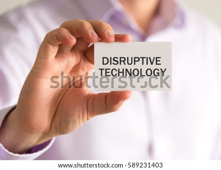 Closeup on businessman holding a card with DISRUPTIVE TECHNOLOGY message, business concept image with soft focus background and vintage tone