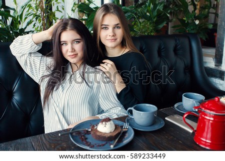 technologies, lifestyle, food, people, teens and coffee concept - Two young women taking selfie with smart phone in the city center. Happiness concept about people and drink tea