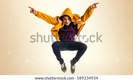 Man dancing street dance on ocher background