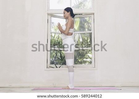 Beautiful woman meditates while practicing yoga. Freedom Beauty fitness woman doing exercises at home Concept of healthy lifestyle.Calmness and relax happiness woman. Toned picture