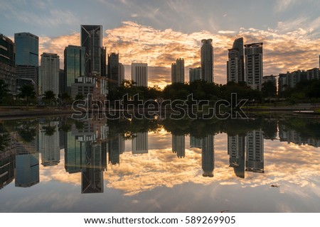 City reflection lake on sunrise. Panoramic and perspective wide angle view and background of glass high rise building skyscraper commercial modern city of future
