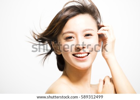 smiling  young Woman with hair motion Royalty-Free Stock Photo #589312499