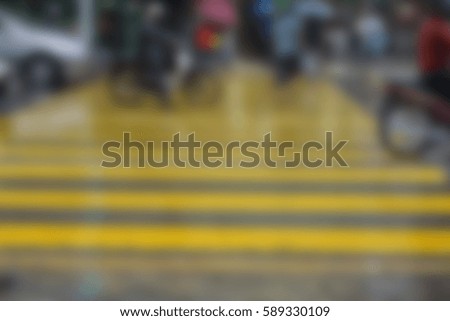 Blurred image of busy city people crowd on zebra crossing street.