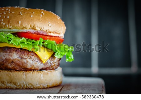 Tasty grilled beef Burger on wood background