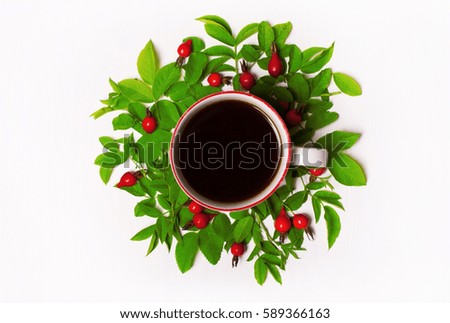 green leaves and red berries, flowers, Cup of coffee on a white background. Flat lay, top view