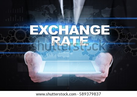 Businessman holding tablet PC with exchange rate concept.