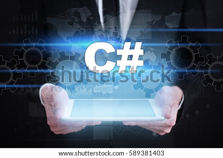 Businessman holding tablet PC with c# concept.