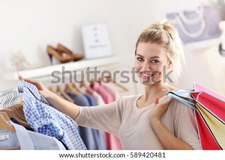 Picture showing happy woman shopping for clothes