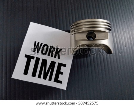 conceptual images of piston/sign word-work time with black board background/selective focus