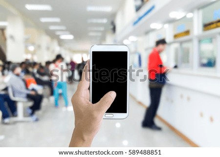 Man use mobile phone, blur image of counter payments as background.