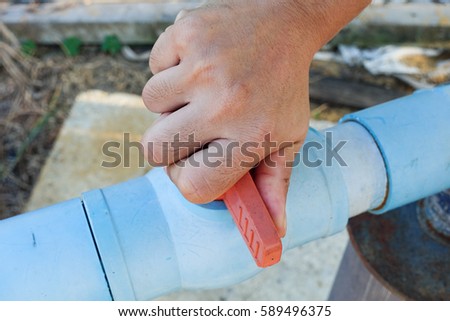 Hand open valve water Royalty-Free Stock Photo #589496375