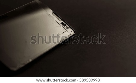 Broken smartphone on a black background