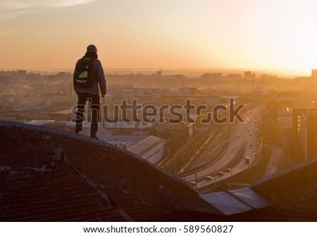 Man on the roof in Omsk at sunset
