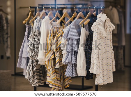 Fashionable clothes in a boutique store in London. Royalty-Free Stock Photo #589577570