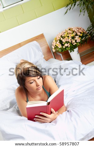 beautiful Woman in bed room with a book