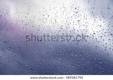 fantasy colour of rain drop on glass window in England UK.