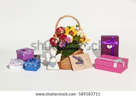 Set of gifts. Sweet set of flowers in basket, different boxes, card and handmade angel on white background.