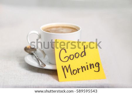 Cup of coffee with note good morning