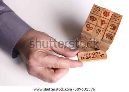 Business, Technology, Internet and network concept. Young businessman shows the word: Employee engagement Royalty-Free Stock Photo #589601396
