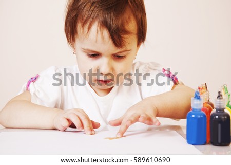 beautiful little baby girl draws a picture paints (postmodernism, talent, creativity, creativity)