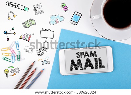 Spam Mail. Mobile phone and coffee cup on a white office desk