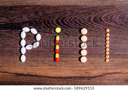 Pharmaceutical medicaments. Word "pill" built with the help of colorful tablets.
