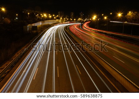 Rays of lights, car lights on a road, at night Royalty-Free Stock Photo #589638875