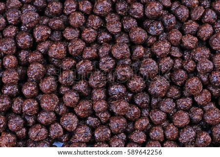 Cereals chocolate flavored breakfast cereal balls as background. Cereal texture pattern.