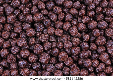 Cereals chocolate flavored breakfast cereal balls as background. Cereal texture pattern.