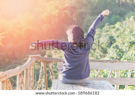 Country home with happy healthy woman feeling good during vacation in natural resort interior. Simple lifestyle people in fresh cozy outdoor park comfortable relaxing morning Royalty-Free Stock Photo #589686182