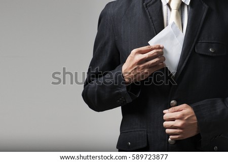 Businessman putting bribe in suit pocket. Corruption concept