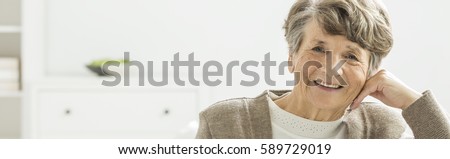 Older happy woman spending afternoon in nursing home Royalty-Free Stock Photo #589729019
