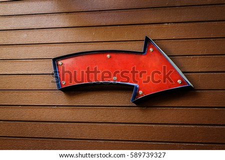 red arrow blank sign against wooden background. Blank screen with copy space