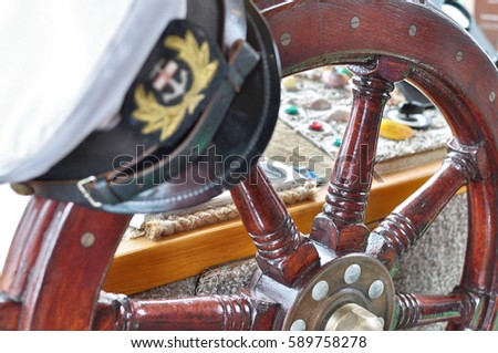 Captain's hat on steering wheel. Travel, transport photography. 