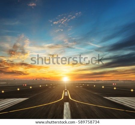 airport runway in the evening sunset light, ready for airplane landing or taking off Royalty-Free Stock Photo #589758734