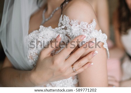 bride touching her beautiful and gentle wedding dress