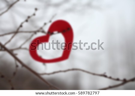 Blurred background of red heart decoration hanging on a branch, Valentine day concept. 