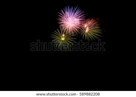 Beautiful colorful holiday fireworks on dark sky background.Colorful and Artistic Fireworks Display over the  Lake.