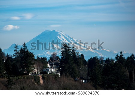 Towering Rainier: Mount Rainier towers over the Pacific Northwest. Royalty-Free Stock Photo #589894370