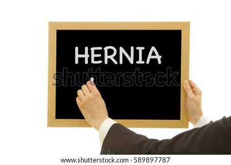 Woman hand writing HERNIA on chalkboard isolated on white background.