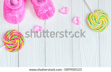 birth of child - lollipop on wooden background