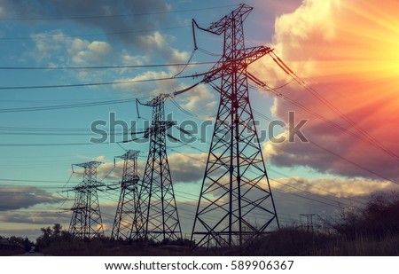  high-voltage  power lines at sunset. electricity distribution station . Royalty-Free Stock Photo #589906367