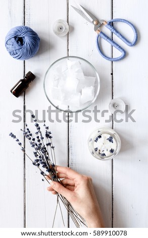 handmade candles with lavender on wooden background top view
