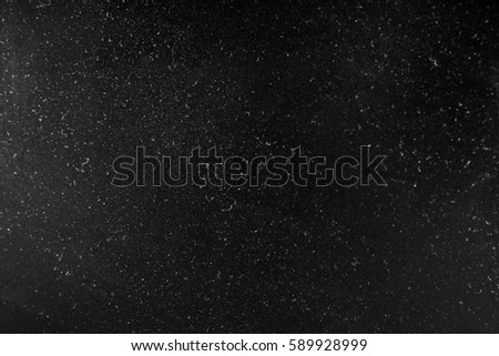 Abstract texture with dust and spots of light. Black tone glitter background.
