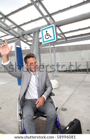 Businessman in wheelchair calling out for a taxi