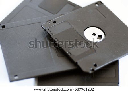 various old obsolete 3 inch floppy disk on white