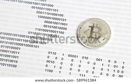 silver bitcoin on the background of binary code