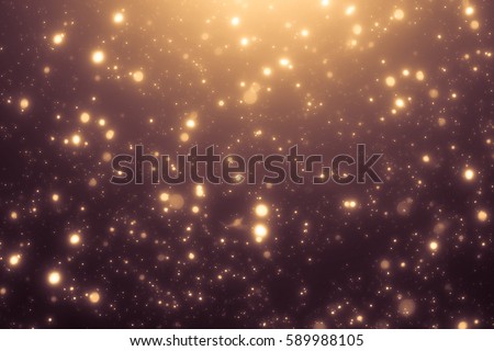 Xmas Golden abstract sparkles or glitter lights. Festive gold background. Defocused circles bokeh or particles. Template for design. 2020 Royalty-Free Stock Photo #589988105
