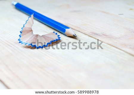 Pencil sharpener shavings on a wooden table. Back to school. Copy space.