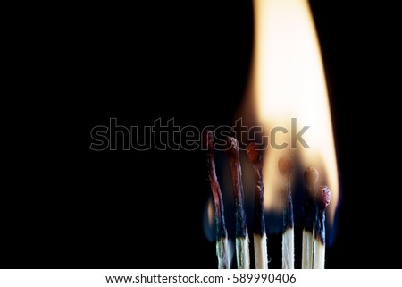Burnt match in a smoke on a black background
